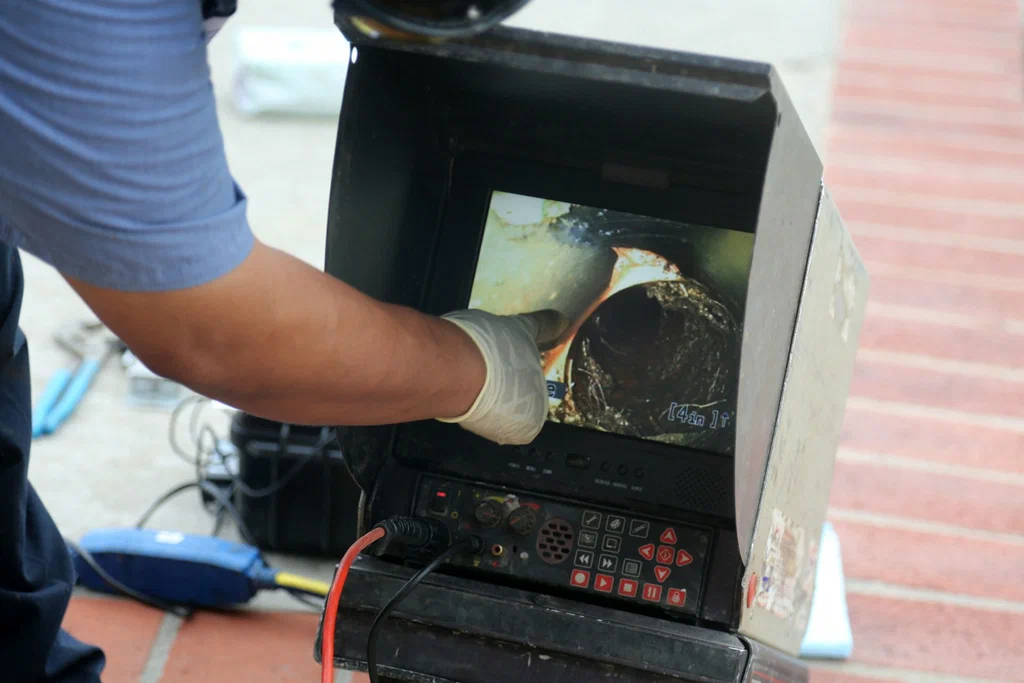 Technician viewing a drain inspection camera in Venice